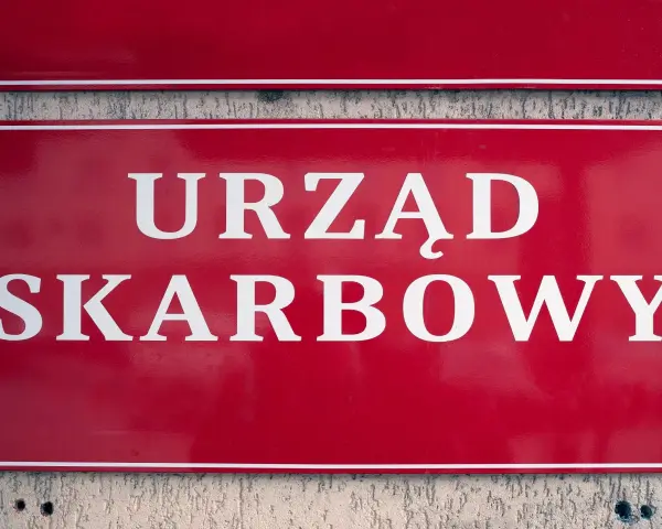 Czerwony szyld z białym napisem "URZĄD SKARBOWY". Właściciel konta bankowego powinien pamiętać o obowiązkach wobec urzędu skarbowego.
